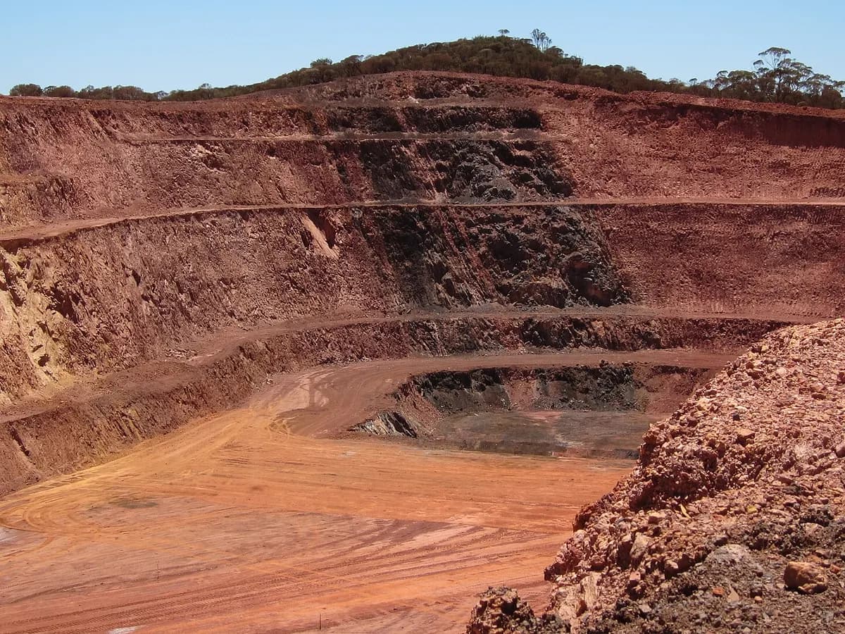 Red ore face in a benched open-pit mine
